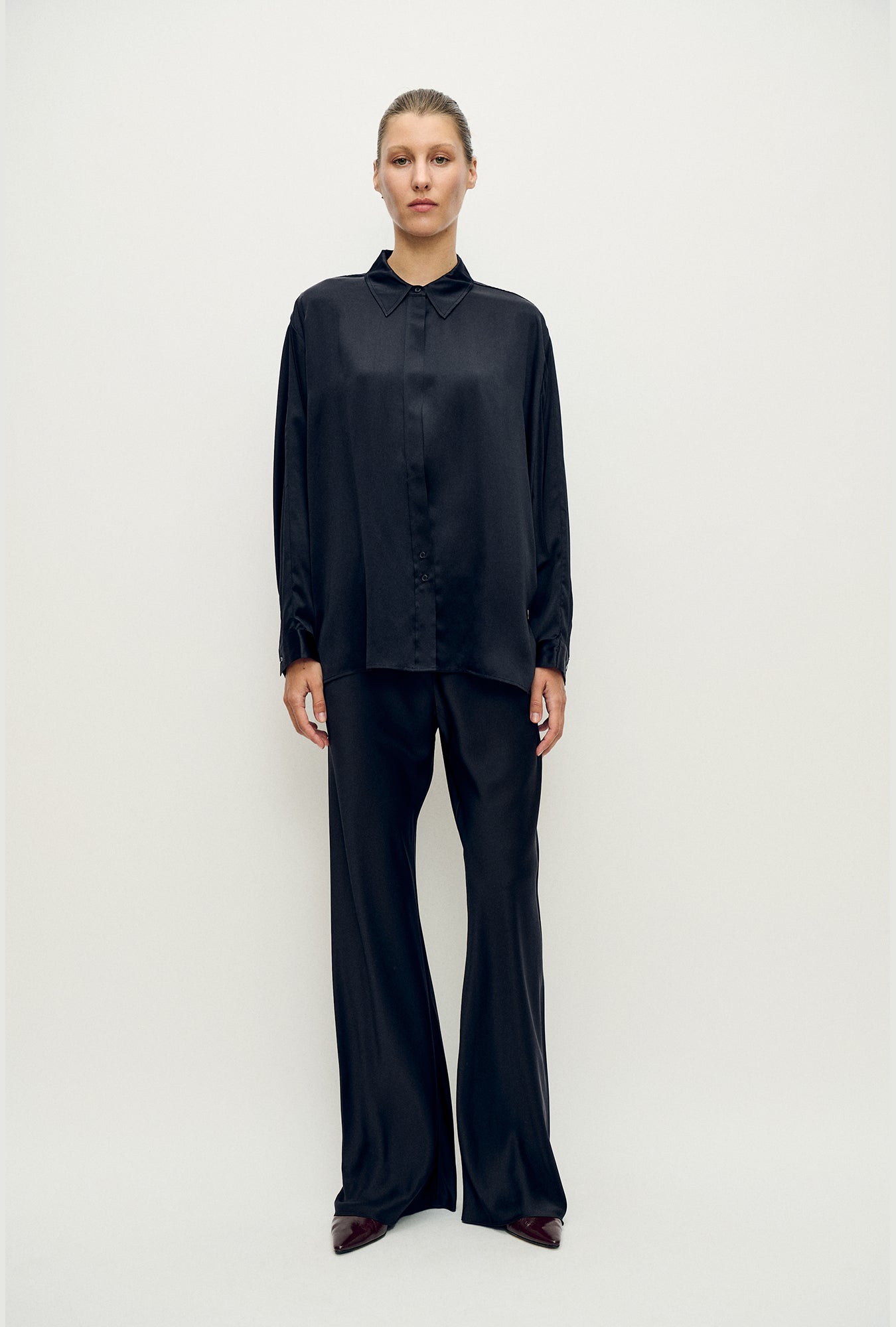 Black silk Bias Cut Pants by Silk Laundry showing the fluid bias cut drape and gentle flare